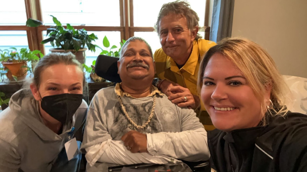 A photo of Javid with his social workers and support team.